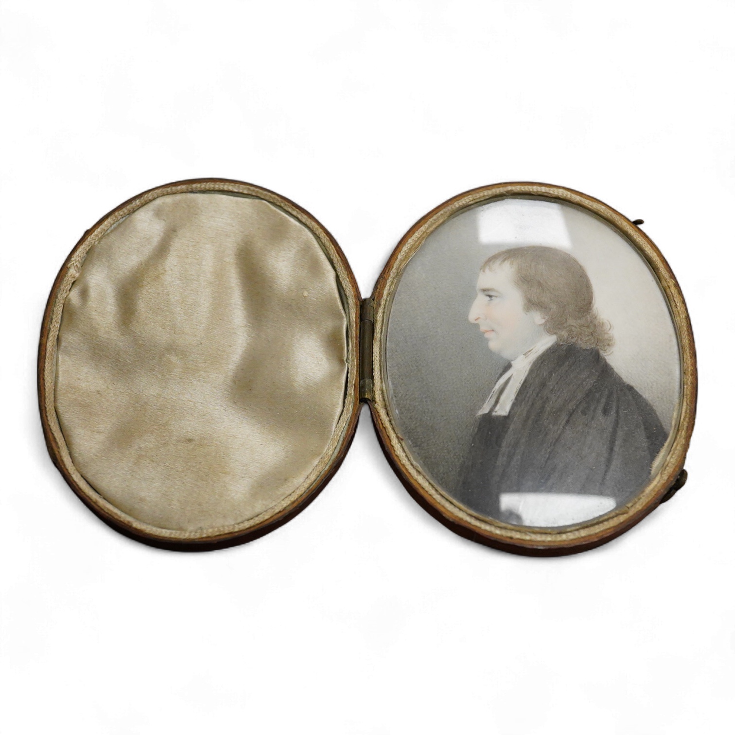 Early 19th century, English School, Portrait miniature of a clergyman, oval watercolour on ivory, housed in a fitted silk and red leather case, 7 x 5.5cm CITES Submission reference, FNKXXK84